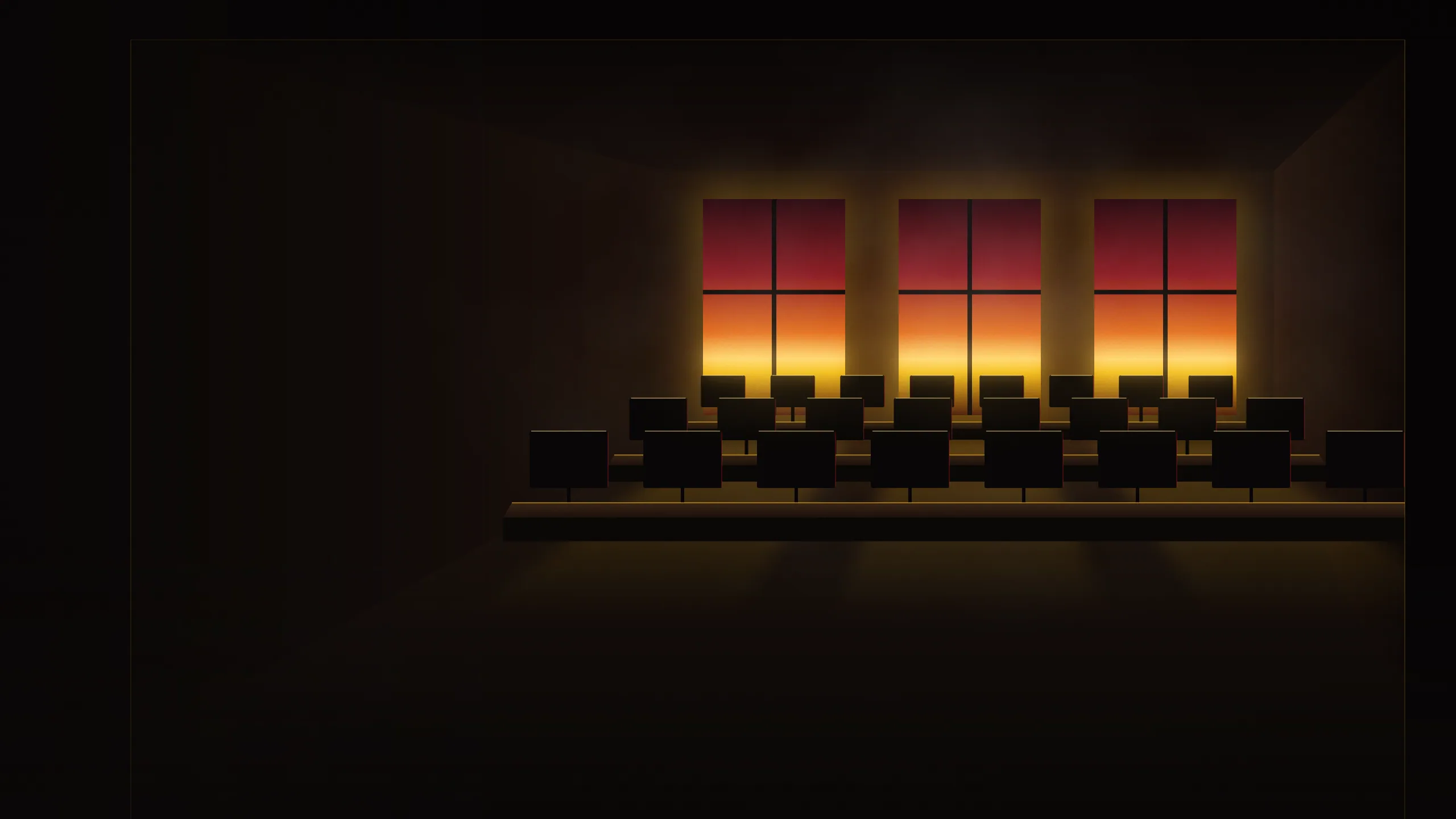 Illustration of an empty studio room at dusk seen from a doorway, rows of desks and dark monitors silhouetted against warm windows.